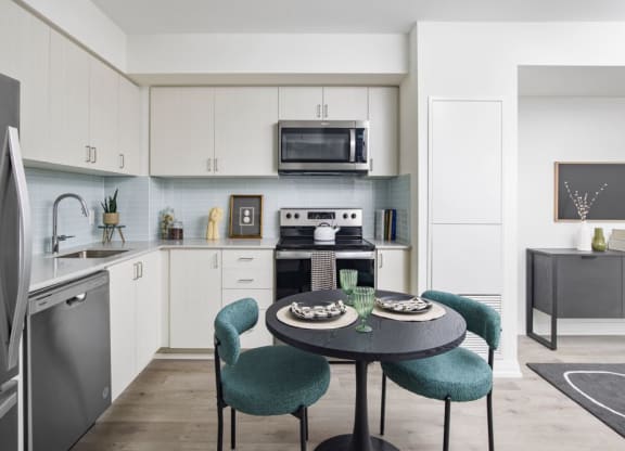 a kitchen and dining room with a table and chairs