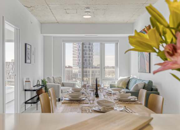 A dining room with a table set for a meal.