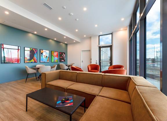 A modern living room with a large sectional sofa and a coffee table.