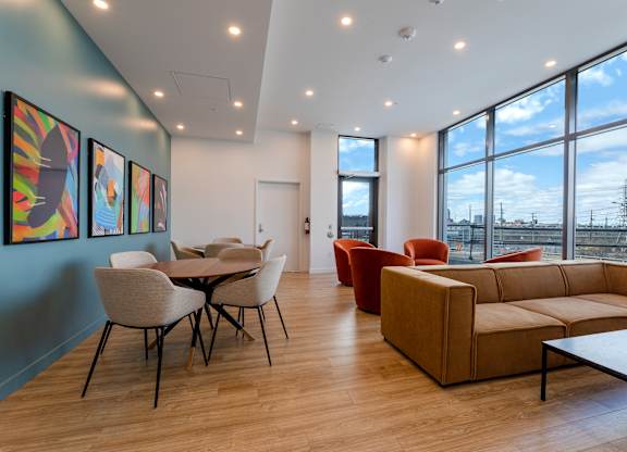 A room with a table and chairs and a couch.