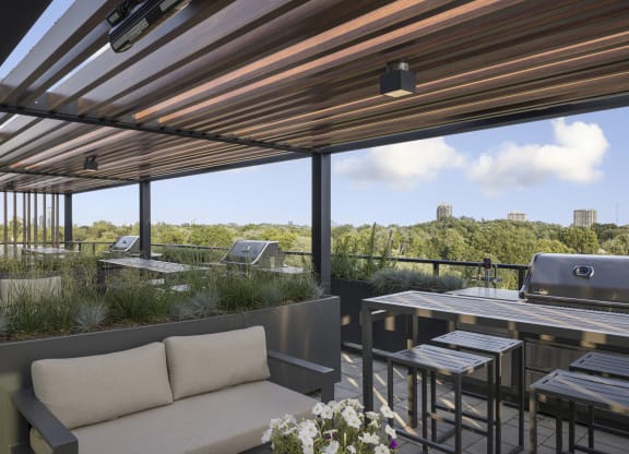 a patio with a table with chairs and a grill
