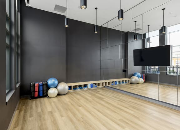 a bowling alley with bowling balls and a tv
