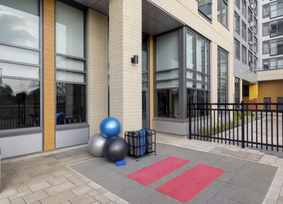 a set of balls and other equipment outside of a building