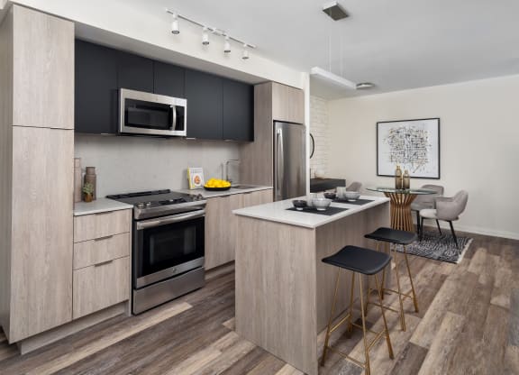 a kitchen with a center island and a stove and a microwave