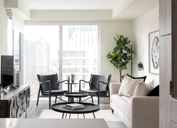 a living room with a couch and chairs and a television