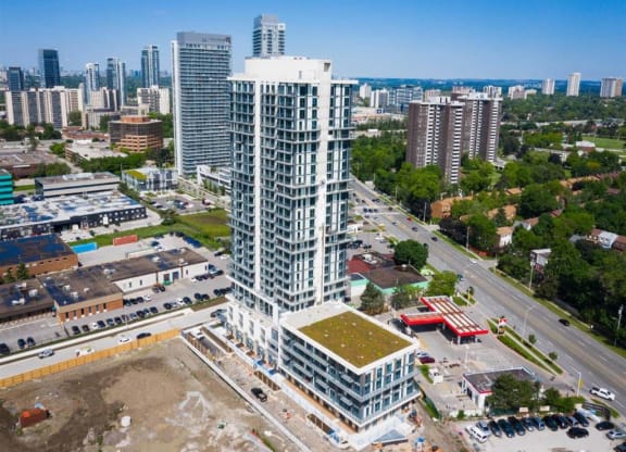 an aerial view of a skyscraper with a city in the background