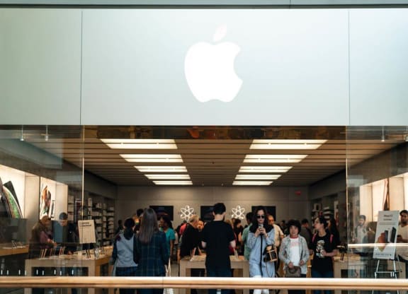 people standing in front of an apple store
