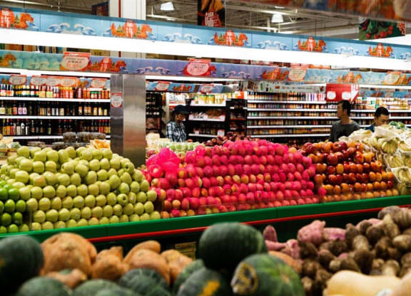 a supermarket with a display of fruits and vegetables