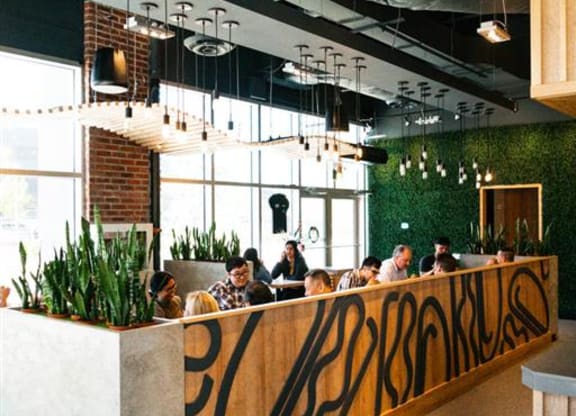 a group of people sitting at a table in a restaurant