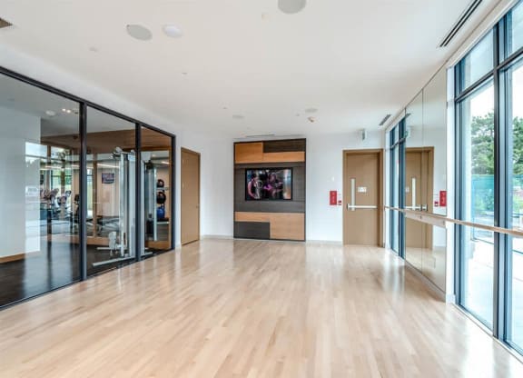 the living room has a large wood floor and glass doors