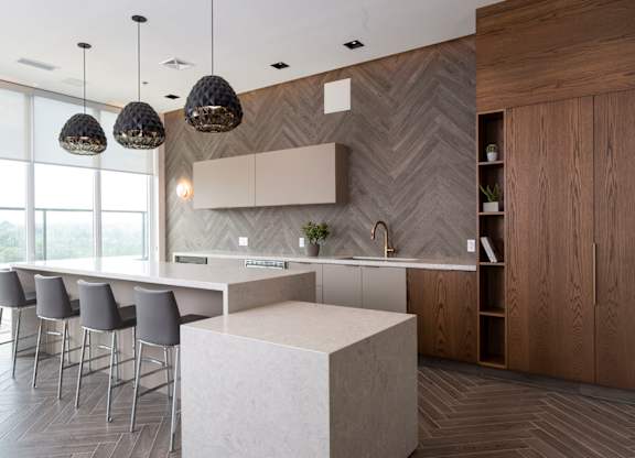 a large kitchen with a large white island and chairs