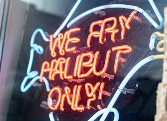 a neon sign in a window that reads we are halliburton only