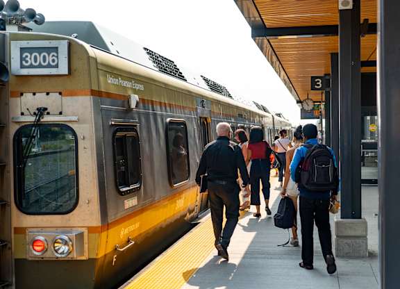 A train with the number 3006 on it is at the station.