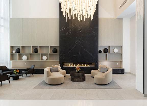 A modern living room with a fireplace and a chandelier.