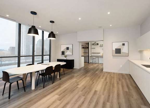 A modern kitchen with a dining table and chairs.