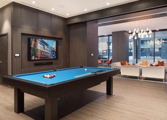 a pool table in a living room with a tv