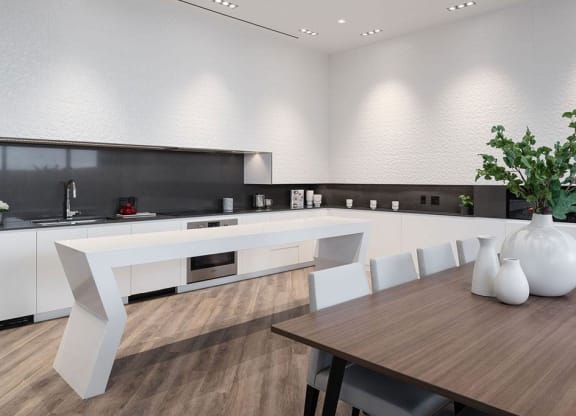 a large white kitchen with a table and chairs