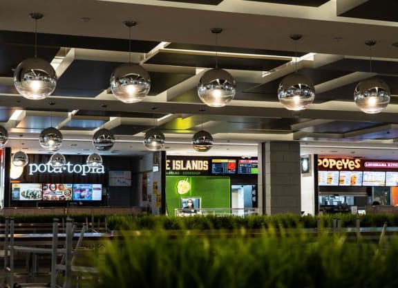 a restaurant in a mall with tables and chairs