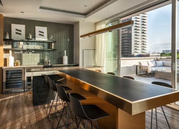 a kitchen with a long counter top and a table with chairs