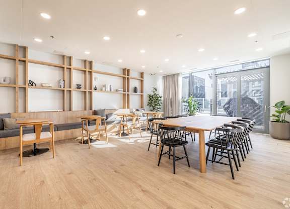 A modern living room with a long wooden table and chairs.