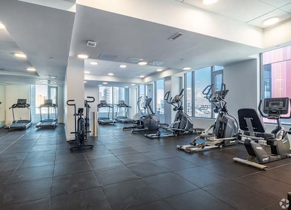 A spacious gym with a variety of exercise equipment.