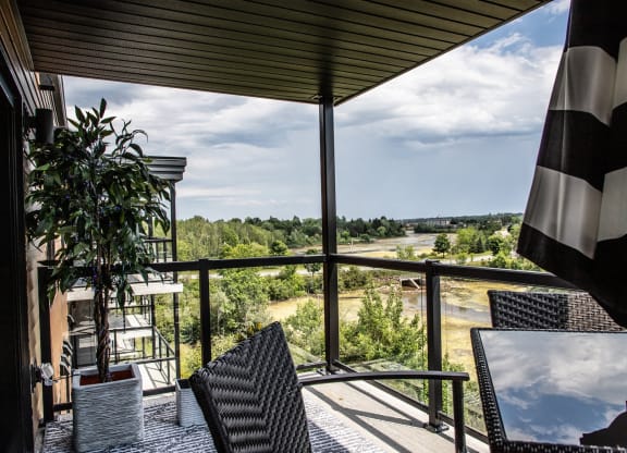 a balcony with a view of a field and trees