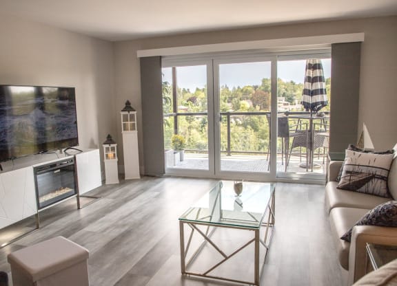 a living room with a bunch of glass windows