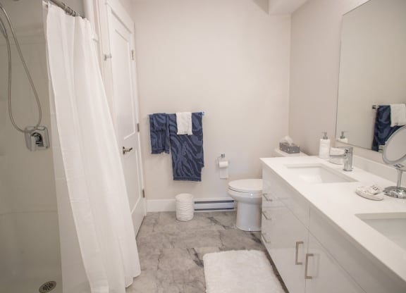 a small bathroom with a shower toilet and sink