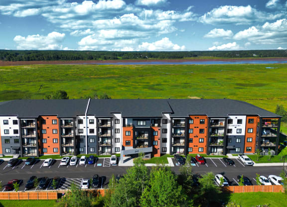 an aerial view of an apartment complex with a river in the background