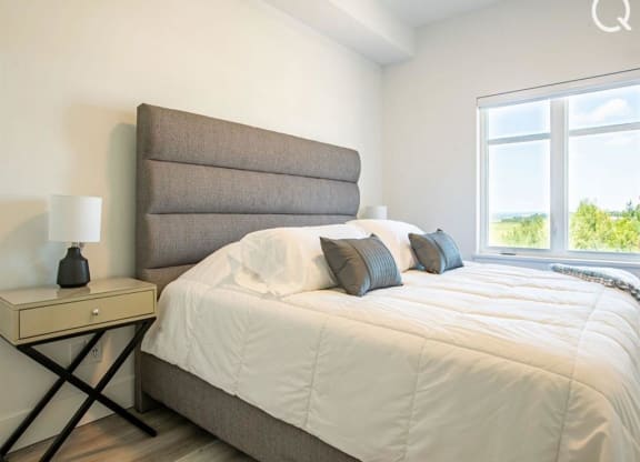 a bedroom with a large bed and a large window