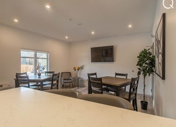 a living room with a bar and a table and chairs