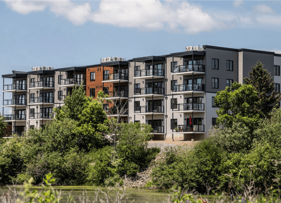 an apartment building on the side of a river