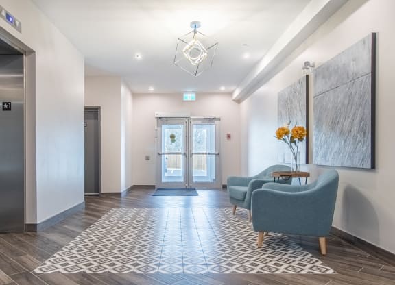 a lobby with couches and chairs and a door
