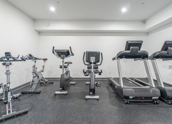 a gym with treadmills and other exercise equipment