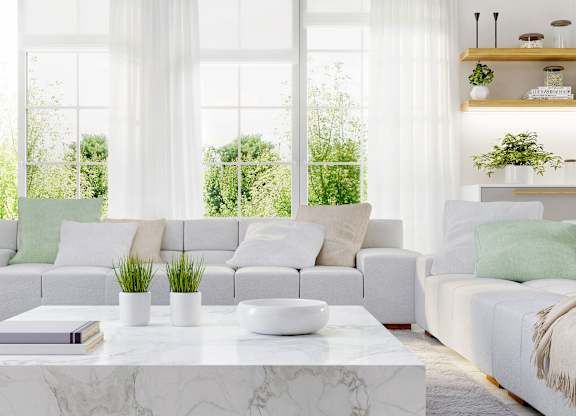 a white living room with couches and a coffee table