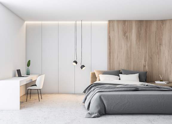 a bedroom with a bed and a desk