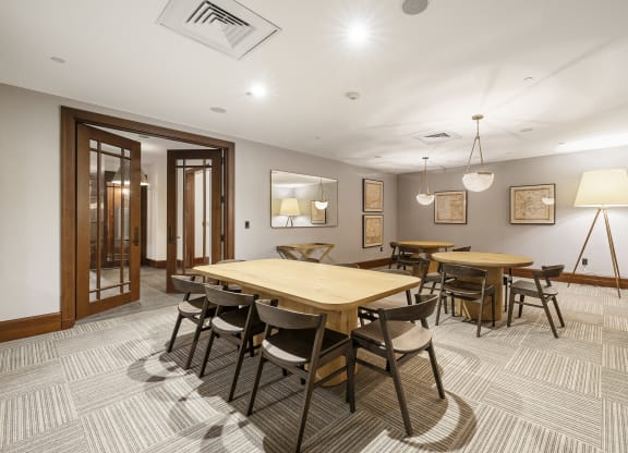 a dining room with a wooden table and chairs at HIGHGROVE, Stamford, 06901
