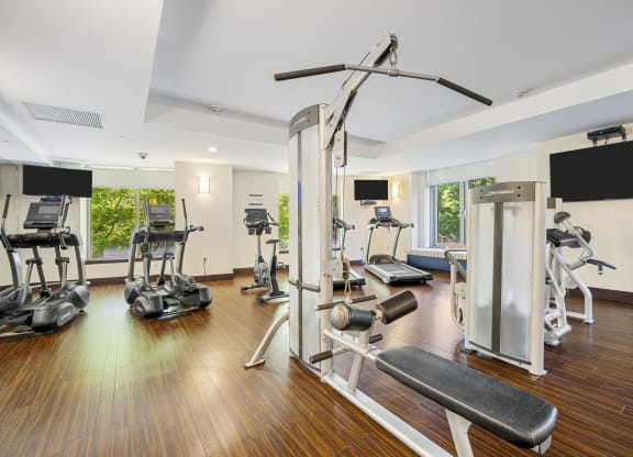 a gym with treadmills and other exercise equipment on a wooden floor at HIGHGROVE, Connecticut