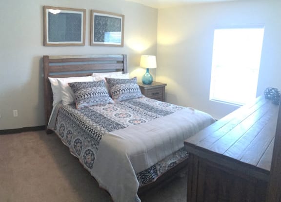 a bedroom with a bed and a dresser
