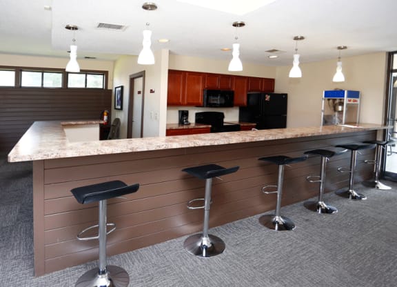 a kitchen with a counter top and stools