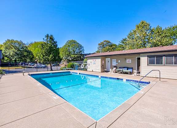 A swimming pool in a sunny backyard.