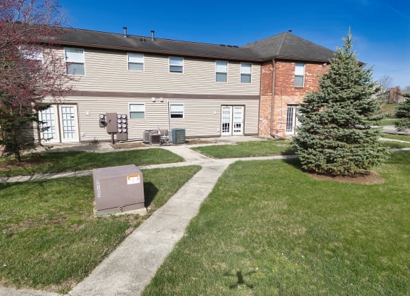 the front of a house with a yard and a mailbox