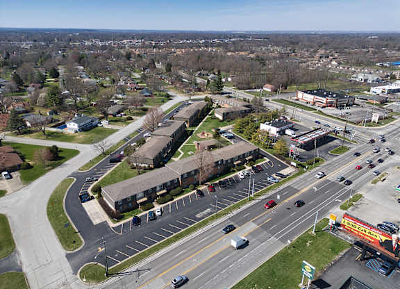 an aerial view of a city street with cars and buildings