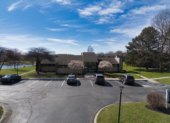 a parking lot with cars in front of a house