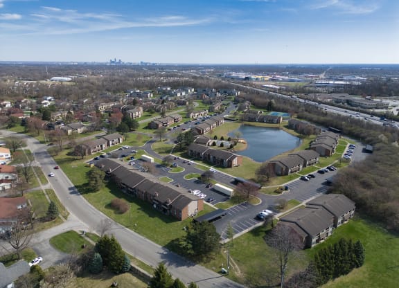 an aerial view of a neighborhood with houses and a lake