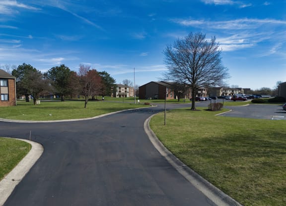 a roundabout in the middle of a neighborhood with houses and trees