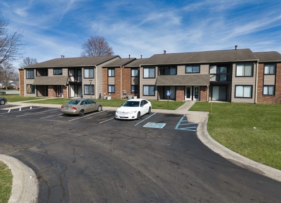 an apartment building with cars parked in front of it