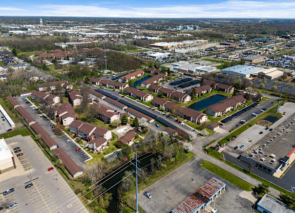 an aerial view of a neighborhood of houses and cars in a parking lot