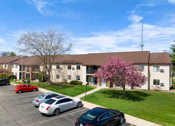 a large building with cars parked in front of it