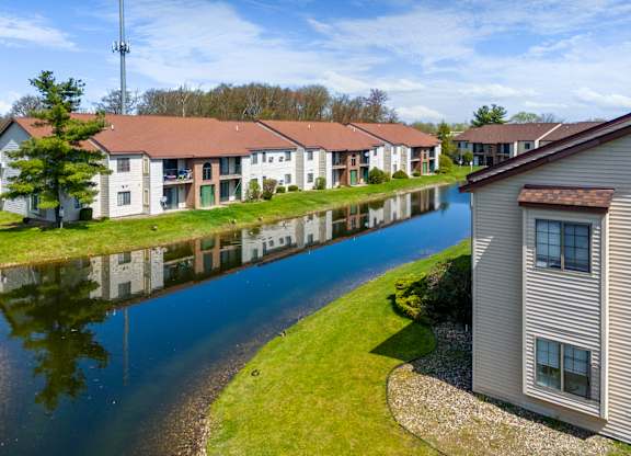 a group of houses next to a body of water